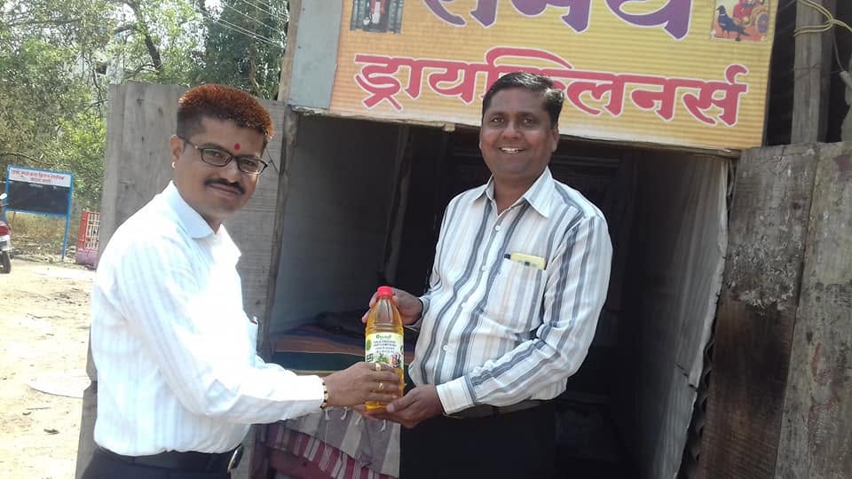 Orgasai oil bottle being handed over at a local shop