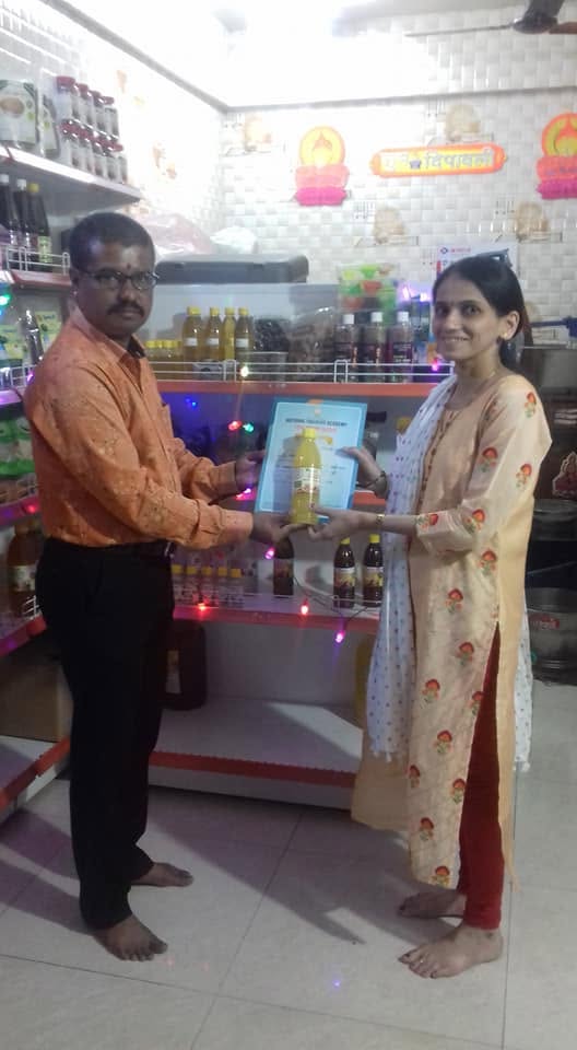 Orgasai being felicitated with a certificate at a partner store