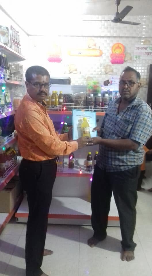 Orgasai being felicitated with a certificate at a partner store