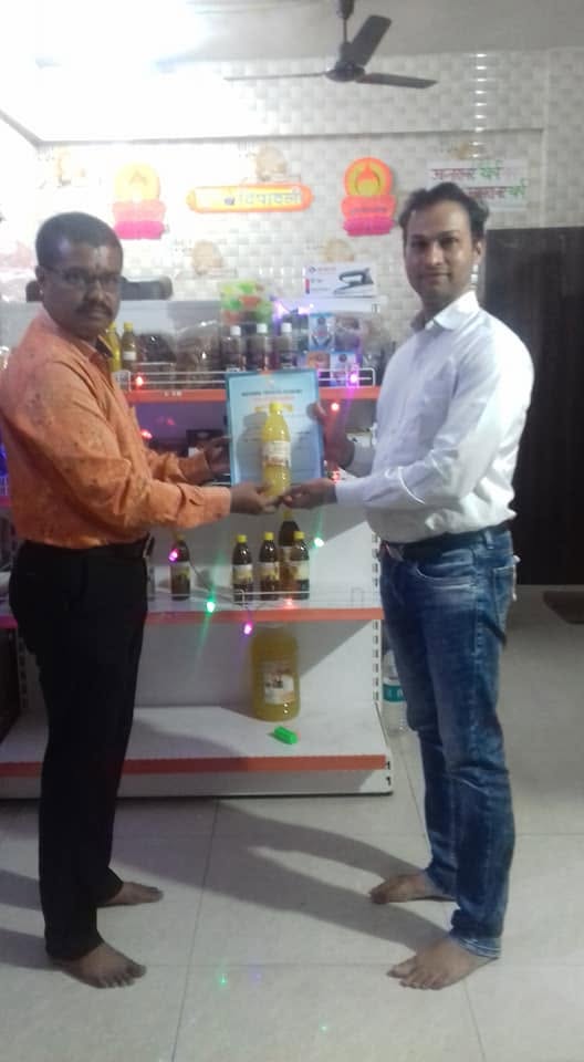 Orgasai being felicitated with a certificate at a partner store