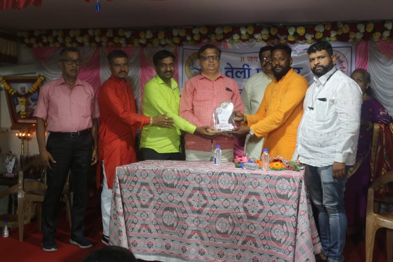 Orgasai representative honoured on stage at a Teli Samaj event